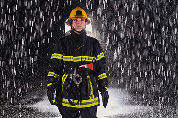 Image showing A determined female firefighter in a professional uniform striding through the dangerous, rainy night on a daring rescue mission, showcasing her unwavering bravery and commitment to saving lives.