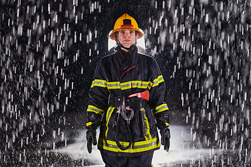 Image showing A determined female firefighter in a professional uniform striding through the dangerous, rainy night on a daring rescue mission, showcasing her unwavering bravery and commitment to saving lives.