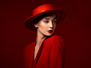 Image showing Fashion, thinking and woman in red hat in studio isolated on a background mockup space. Makeup, cosmetics and female model in fedora, serious style and classy clothes with aesthetic, vision and idea