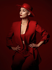 Image showing Vision, fashion and a woman thinking on a red studio background for elegant or trendy style. Aesthetic, future and beauty with a young female model standing hands on hips while looking edgy or classy