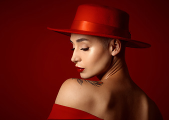 Image showing Back, fashion and a model woman on a red studio background for elegant or trendy style. Aesthetic, face and beauty with a young female person in an edgy, classy or unique outfit for a magazine cover