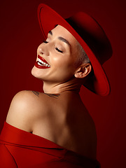 Image showing Fashion, funny and a model woman on a red studio background for elegant or trendy style. Aesthetic, art and beauty with a young female person laughing in an edgy or classy unique clothes outfit