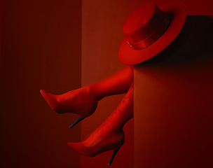 Image showing Red shoes, hat and closeup in studio, sexy and aesthetic for retro couture design, luxury clothes or mystery by background. Stiletto heels, feet and relax for high fashion, elegance and vintage style