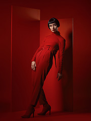 Image showing Fashion, retro and portrait of a woman on a red background for a sexy, creative and vintage aesthetic. Pose, luxury and a model in clothing with wealth and makeup isolated on a studio backdrop