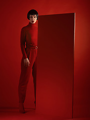 Image showing Fashion, art and portrait of woman with red board, futuristic makeup and unique studio background. Future aesthetic, cyberpunk and creative beauty, body of model in dark luxury designer brand mockup.