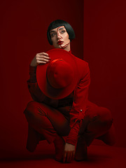 Image showing Woman, fashion and art deco, red aesthetic with beauty and makeup with vintage style shine on studio background. Female model, thinking and bold cosmetics, female model with glamour and creative