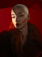 Image showing Portrait, fashion and serious woman in red coat in studio isolated on a background. Face, makeup and bald female model with cosmetics, aesthetics or stylish, trendy or classy clothes from Switzerland