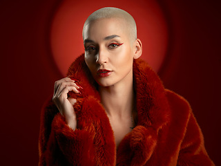 Image showing Fashion, portrait and confident woman in a red coat in studio isolated on a background. Face, makeup and serious model with cosmetics, aesthetic and style, trendy and fur clothes from Switzerland.