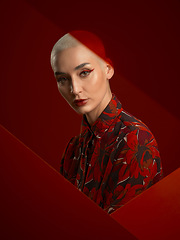 Image showing Woman, fashion and portrait with red aesthetic, beauty and makeup with floral shirt isolated on studio background. Skin glow, female model with serious expression and cosmetics, attractive and bold