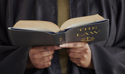 Image showing Hands, law or lawyer reading book, constitution research or education for learning the justice system. Guide, advocate or closeup of attorney studying knowledge, guide or information for legal agency