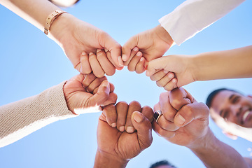 Image showing Big family, fist bump and teamwork synergy in circle for support, trust or unity in collaboration outdoors. Low angle of people or friends touching hands for team building, community or goals outside