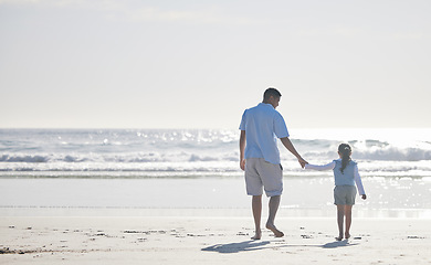 Image showing Beach, holding hands and father and kid walking for outdoor peace, freedom and fresh air on vacation holiday. Sea water, mockup ocean view and back of family, dad and young child bond, relax and care