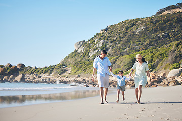 Image showing Beach, mother and father holding hands with a child for fun, family adventure and play on holiday. A happy woman, man and young kid walking on sand for vacation at ocean, nature or outdoor in summer