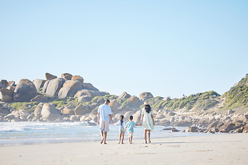 Image showing Travel, holding hands and family at the beach for walking, bonding and on vacation in summer. Care, nature and back of parents and children with affection while on a walk by the sea during a holiday