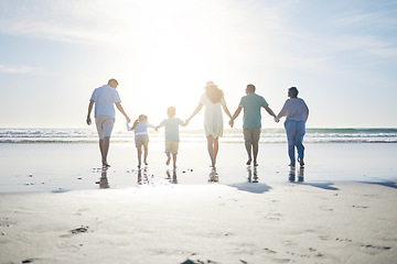 Image showing Beach, holding hands and grandparents, parents and kids for bonding, quality time and relax in nature. Family, travel and back of mom, dad and children walking on holiday, vacation and adventure