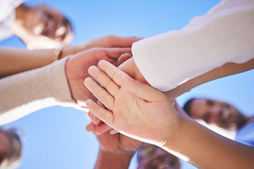 Image showing People, hands together and teamwork below in support for trust, bonding or unity and collaboration outdoors. Low angle of family or friends piling hand for team building, community or goals outside