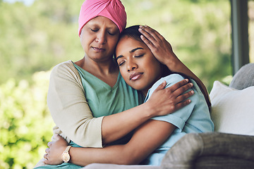 Image showing Family, old woman hugging her daughter and cancer with sad people on a sofa in the home living room during recovery. Love, trust or comfort with a sick senior female parent embracing an adult child