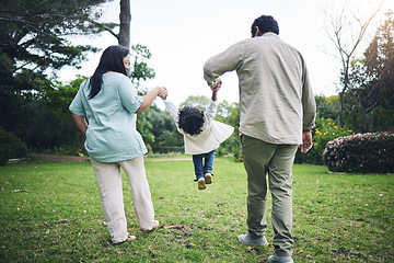 Image showing Parents, garden and holding hands with kid or swing with love and quality time in summer. Care, mother and father with swinging or behind in backyard for bonding with fun or trust and freedom.