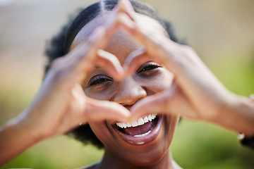 Image showing Happy black woman, portrait and face with heart hands for love, care or healthy wellness in nature. African female person smile with like emoji, symbol or icon and hand gesture for romance outdoors