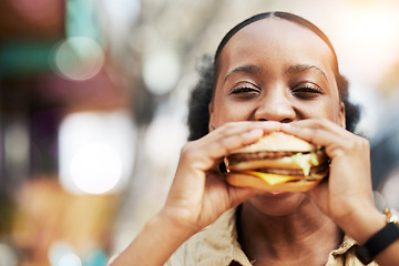 Image showing Portrait, fast food and black woman eating a burger in an restaurant or outdoor cafe as a lunch meal craving. Breakfast, sandwich and young female person or customer enjoying a tasty unhealthy snack