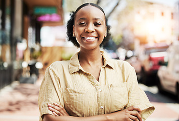 Image showing Happy, smile and portrait of woman in the city walking for exploring, travel or sightseeing. Happiness, excited and headshot of African female person with crossed arms for confidence in an urban town