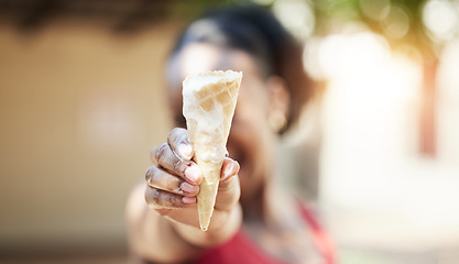 Image showing Black girl, hand and ice cream outdoor in closeup for snack in summer or vacation with blurred in background. Dessert, melting and cone on holiday with person holding tasty and fresh sweet food.