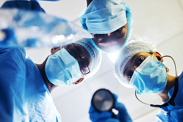 Image showing Surgery, medical and a team of doctors in an operating room at the hospital for a medical procedure from patient pov. Face, mask and teamwork with a group of medicine professionals in an operation