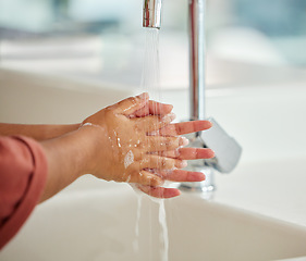 Image showing Washing hands, cleaning and person closeup with hygiene and water for wellness in kitchen. Soap, sink and home with bacteria prevention and safety with disinfection liquid with care using faucet