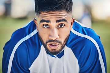 Image showing Soccer player, tired or portrait of man in sports training, game or match breathing heavy on a field pitch. Face, fatigue or exhausted male athlete in football workout or fitness exercise on break