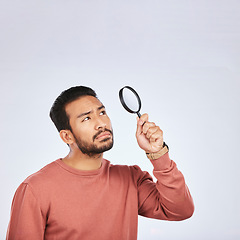 Image showing Magnifying glass, man and serious in a studio with investigation for clues. Isolated, white background and male person with inspection for scam, crime evidence and information search with mockup