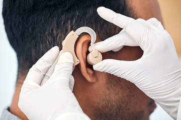 Image showing Hearing aid, man and doctor hands with deaf patient consultation for ear and wellness at hospital. Help, employee and ear test of physician with tinnitus and consulting exam with healthcare expert