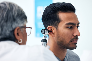 Image showing Ear check, man and ENT doctor with patient consultation for hearing and wellness at hospital. Senior, employee and otoscope test of physician with healthcare work and consulting exam with expert