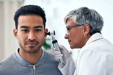 Image showing Ear check, woman and ENT doctor with patient consultation for hearing and wellness at hospital. Senior, employee and otoscope test of physician with health insurance and consulting exam for tinnitus