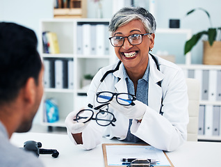 Image showing Optometrist, woman and customer with glasses for man or assessment for service at clinic. Eye doctor, professional and advice with frame or consultation with expert for client or helping with smile.