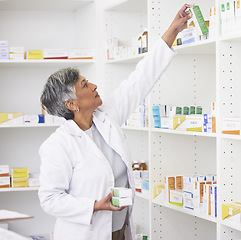 Image showing Mature pharmacist woman, shelf and boxes with thinking, packing stock and inventory inspection. Senior pharmacy manager, package or product for healthcare, pills or ideas with drugs in retail store