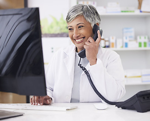 Image showing Pharmacist, telephone and computer for prescription with woman in conversation for retail healthcare. Chemist, working and pharmacy on computer with customer service or medicine with telehealth.