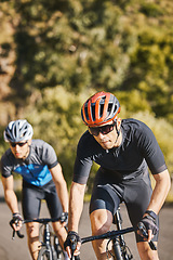 Image showing Men, mountain and cycling for race, fitness and helmet for safety, speed and training for health in summer. Young cyclist athlete, focus and exercise for wellness, performance and workout in sunshine