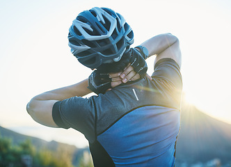 Image showing Man, cycling and neck pain with injury outdoor, stress and helmet for safety, fitness or exercise in sunshine. Cyclist, emergency and medical problem in countryside for workout, race or performance