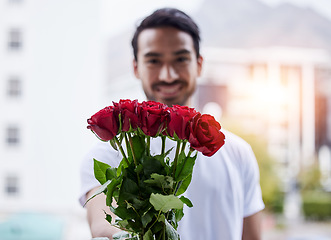 Image showing Love, gift and portrait of happy man with roses for date, romance and valentines day. Smile, romantic hope and person giving bouquet of flowers in city, proposal or engagement on blurred background.