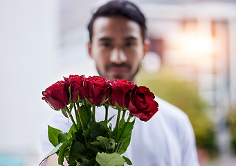 Image showing Love, giving and man with bouquet of roses for date, romance and hope for valentines day. Confession, romantic gift and person holding flowers outside, proposal or engagement on blurred background.