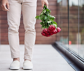 Image showing Love, legs and man with bouquet of flowers for date, romance and hope for valentines day. Romantic confession, floral gift and person holding red roses, standing outside for proposal or engagement.