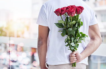 Image showing Love, surprise and man with roses behind back for date, romance and hope for valentines day. Romantic confession, floral gift and person with bouquet of flowers in city for proposal or engagement.