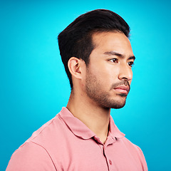 Image showing Thinking, serious and profile of Asian man in studio isolated on a blue background. Idea, side face and male person contemplating, lost in thoughts or problem solving while looking for a solution.