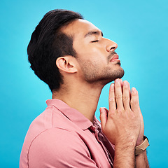 Image showing Profile, religion and praying man in studio isolated on a blue background. Christian, spiritual and male person with prayer, gratitude and faith to worship God, Jesus and Holy Spirit with meditation.