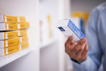 Image showing Pharmacy, medicine and hands of man with pills reading label for medication, prescription and information. Healthcare, clinic and closeup of person with medical product, supplements and antibiotics