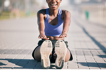Image showing Exercise, happy woman and stretching legs to touch feet for fitness, training or performance on urban ground. Female athlete, smile and warm up for flexible workout, muscle mobility and sports in sun