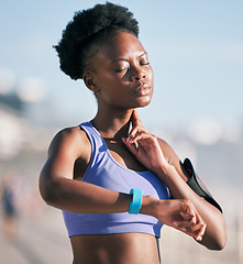 Image showing Fitness, wellness and athlete checking her pulse with smartwatch for running outdoor in nature. Sports, workout and African woman monitoring her heart rate for cardio training for race or marathon.