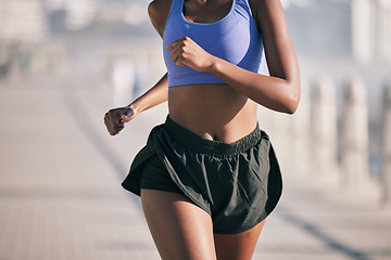 Image showing Closeup, sports woman and running motion in sunshine for marathon race, performance and fitness. Female runner, cardio training and summer workout for energy, fast action and power of urban exercise