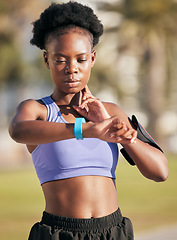 Image showing Fitness, exercise and woman checking her pulse with smartwatch for running outdoor in nature. Sports, workout and African female athlete monitoring heart rate for cardio training for race or marathon