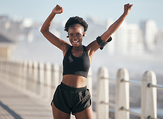 Image showing Dance, fitness and portrait of woman by city beach for energy, exercise and cardio health with music technology. Listening, training and celebration, winning or yes of African person or runner goals